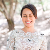 Happy bride laughing wearing a black and white floral lace wedding dress